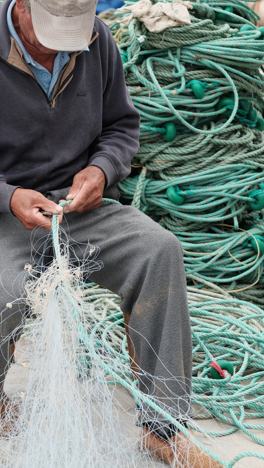Fisherman cleaning nets
